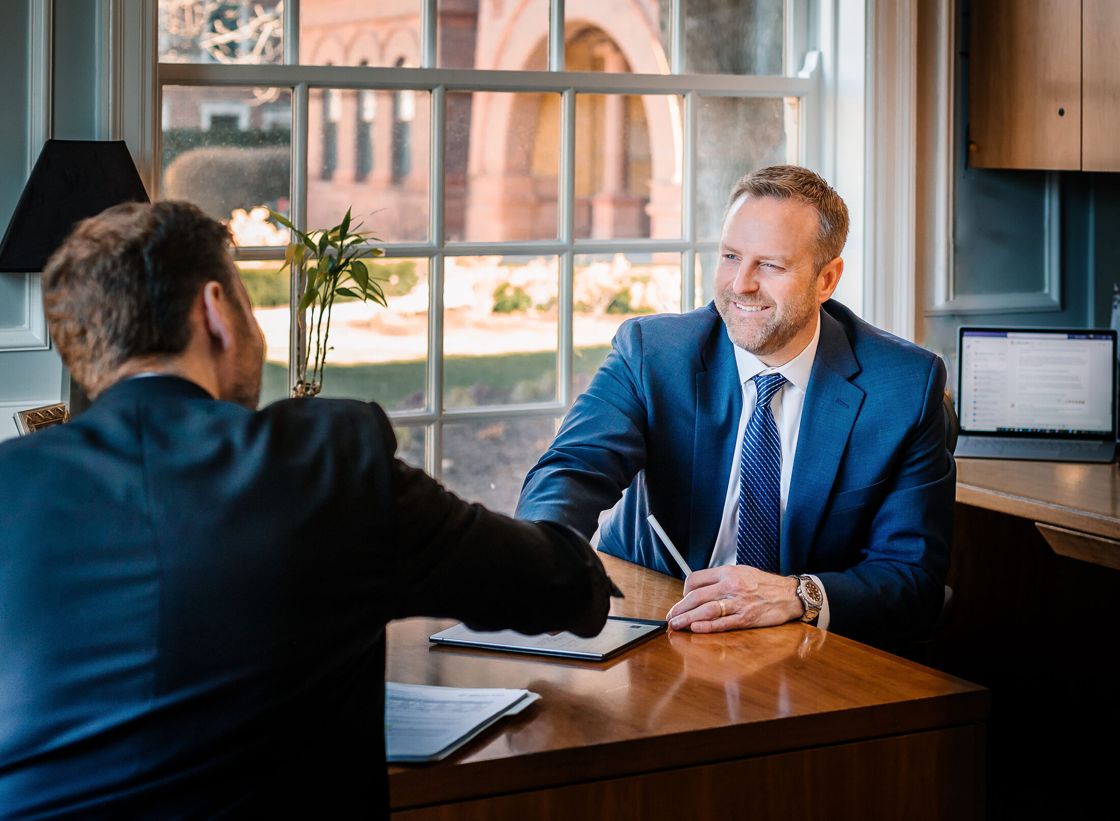 A Paulson Wealth advisor greeting a client