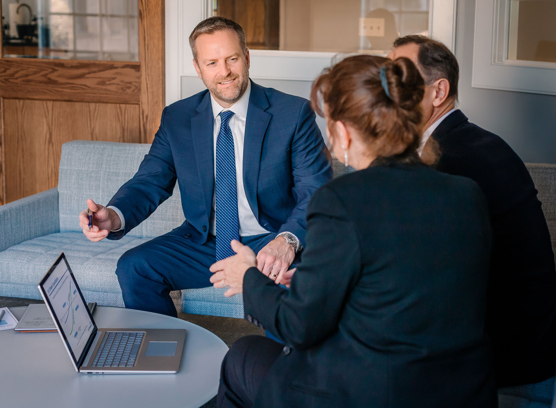 A Paulson Wealth advisor meeting with clients in the Wheaton office